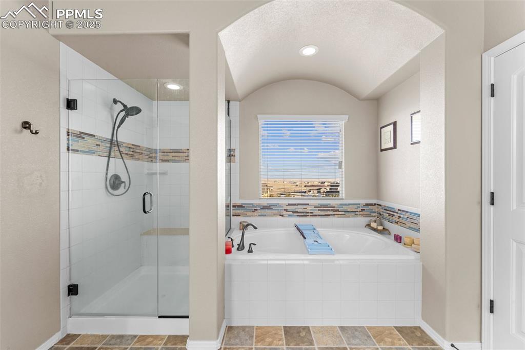 Image 45 of 50: Bathroom featuring separate shower and tub
