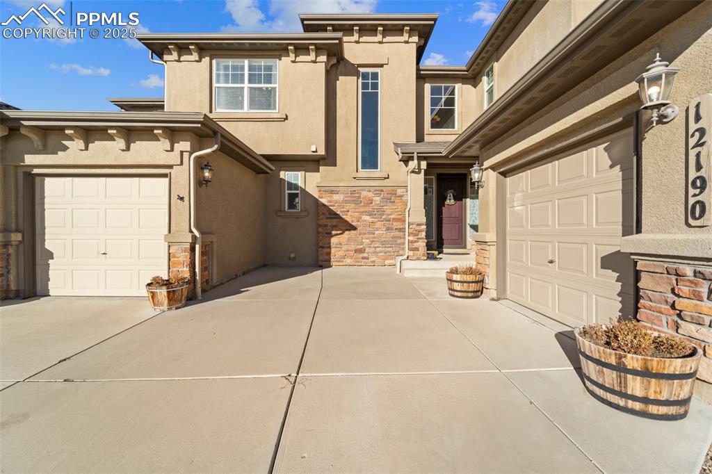 Image 6 of 50: View of front of home with a garage