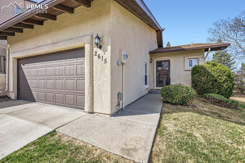 Caption: View of property exterior with 2 car garage 