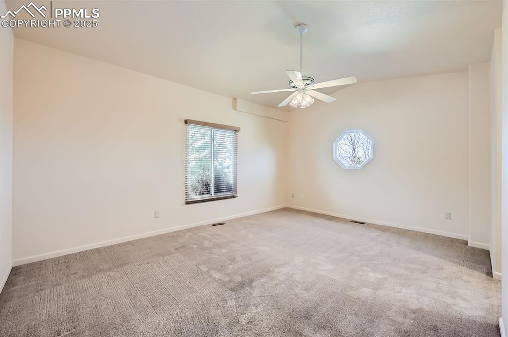 Image 10 of 27: Unfurnished room with a wealth of natural light, ceiling fan, baseboards, a