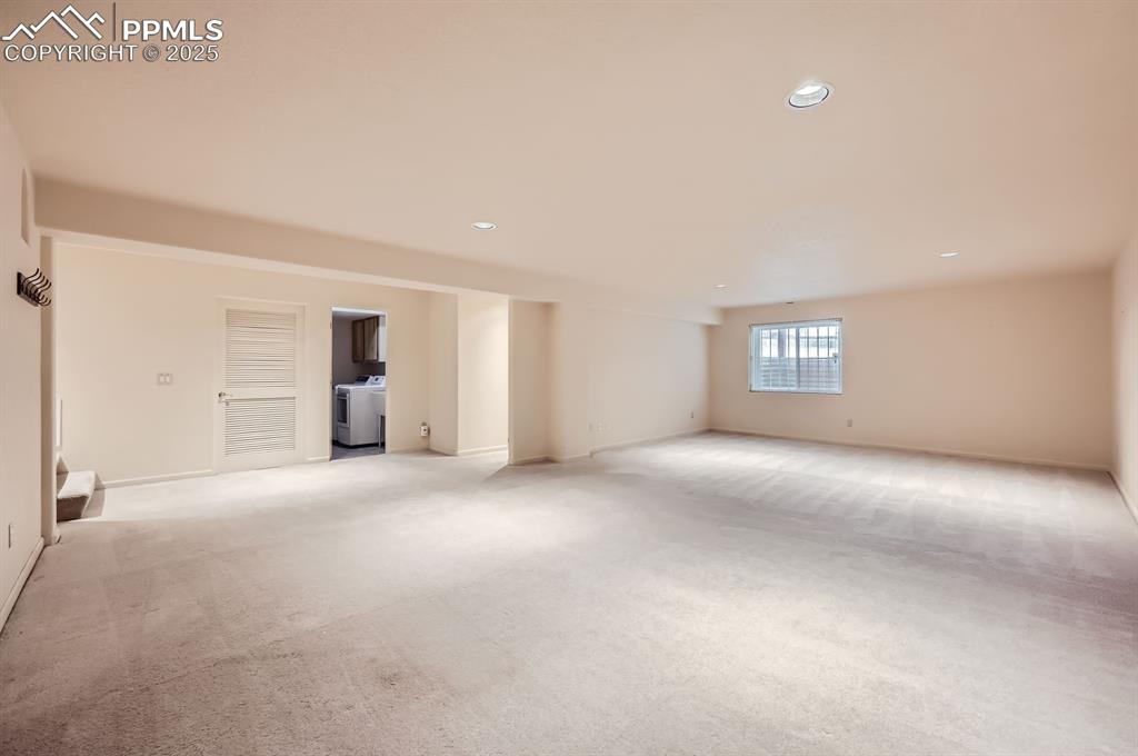 Image 16 of 27: Empty room with recessed lighting, washer / dryer, light colored carpet, an