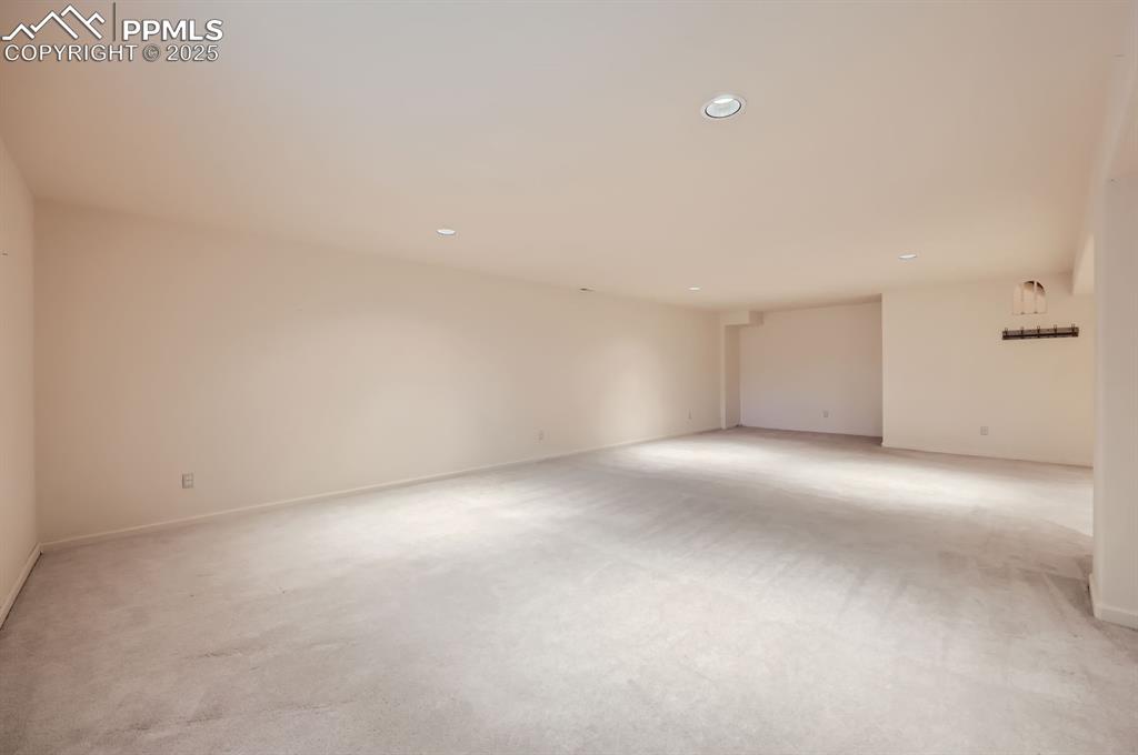 Image 18 of 27: Unfurnished room with baseboards, recessed lighting, and light carpet