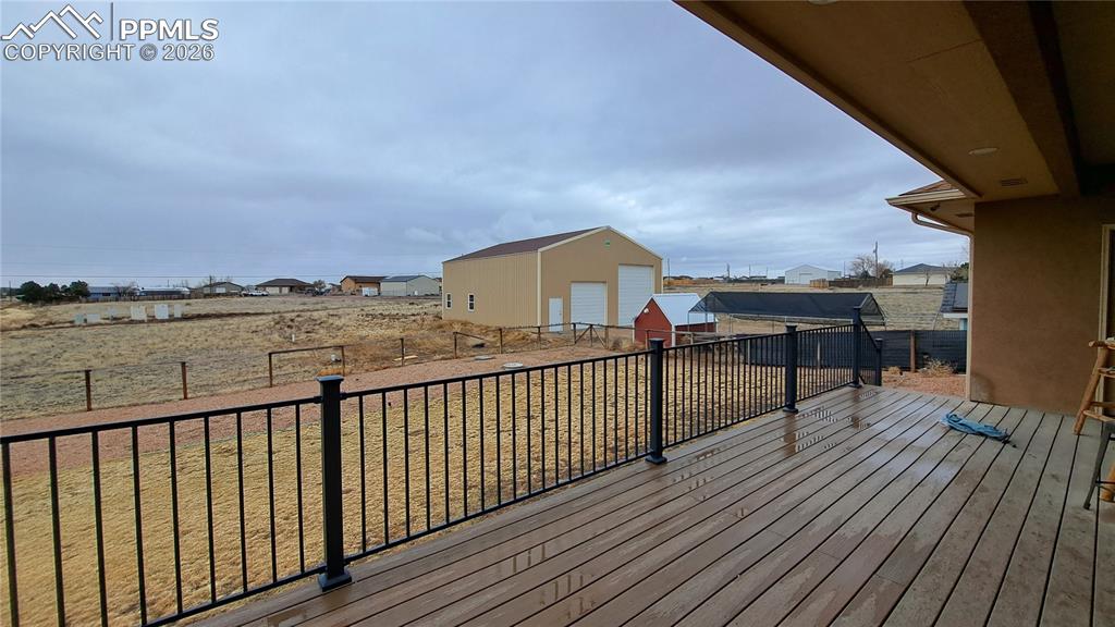 Image 38 of 40: Large covered deck with mountain views