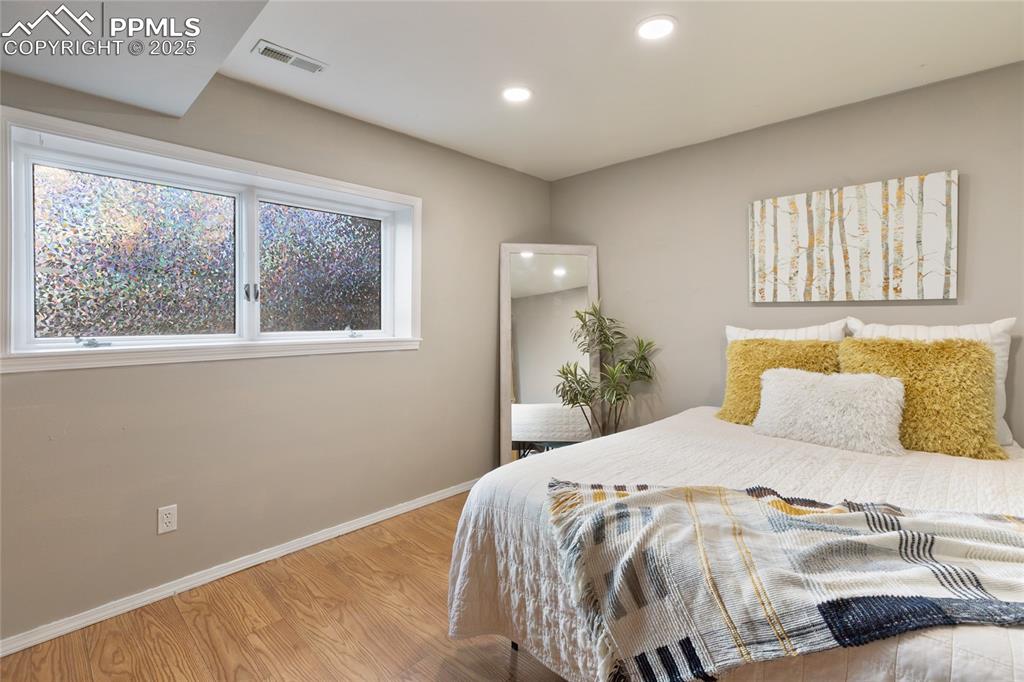 Image 29 of 44: Basement guest room with large windows