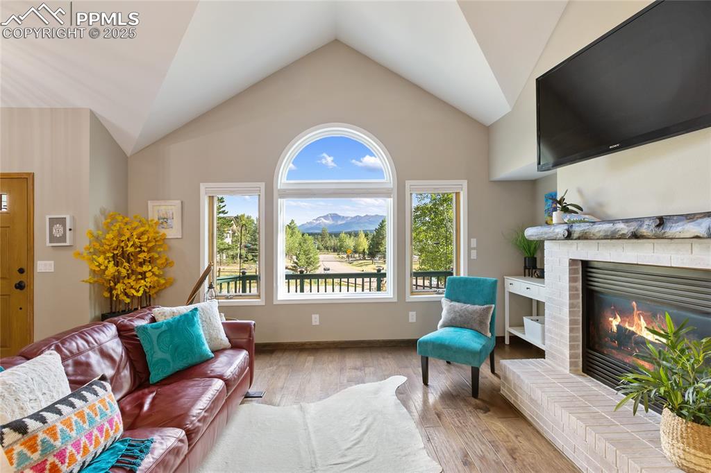 Image 3 of 44: Great room with vaulted ceilings and breathtaking Pikes Peak view