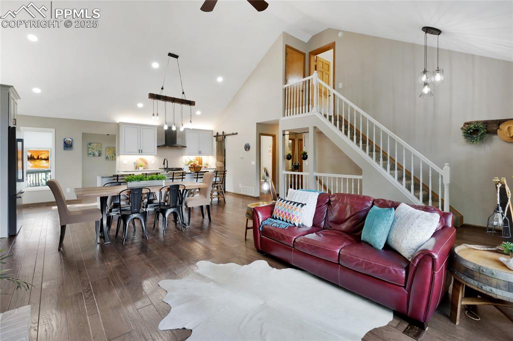 Image 4 of 44: Vaulted ceiling with stairs leading to 1 of 2 bedroom suites