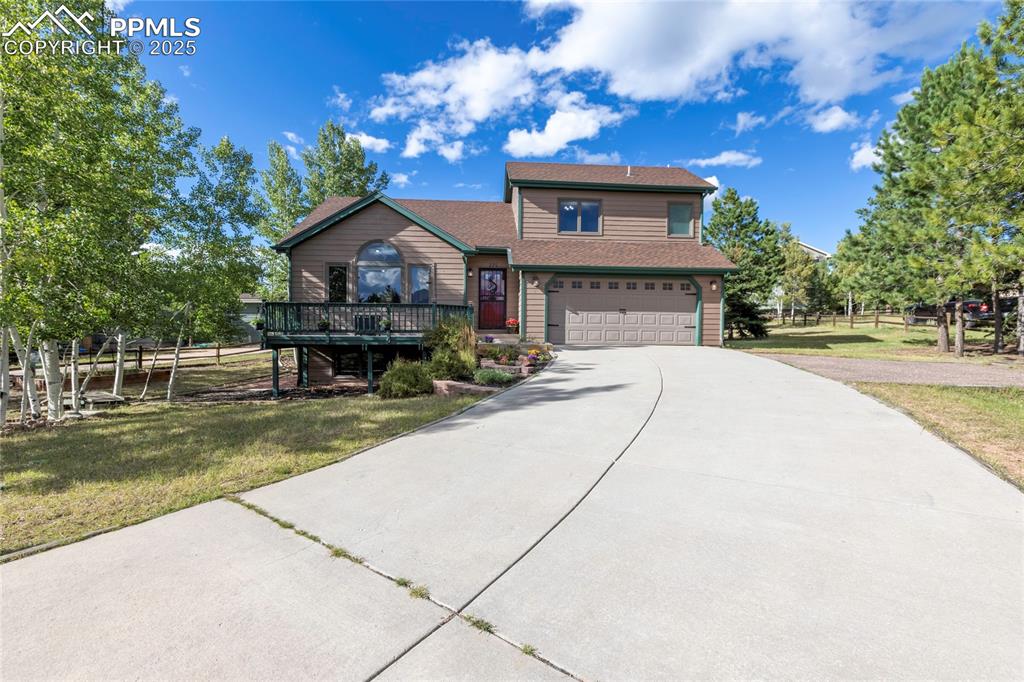 Image 41 of 44: View of front of property featuring driveway, an attached garage, and roof