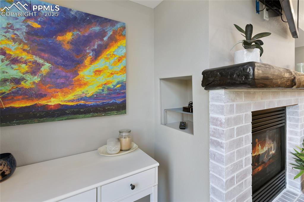 Image 7 of 44: Niche hides electronics cords and keeps remotes tidy
