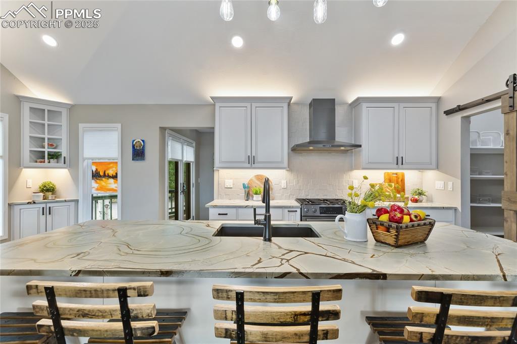 Image 8 of 44: Gorgeous luxury kitchen with Blue Roma Leather finished stone slab countert