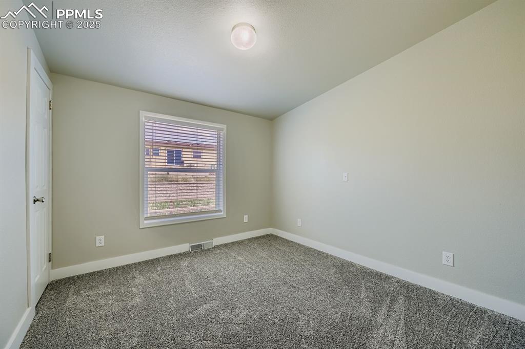 Image 11 of 28: Empty room featuring baseboards and carpet