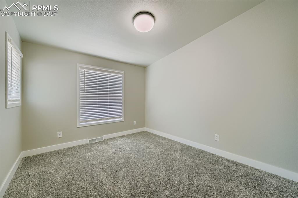 Image 15 of 28: Unfurnished room featuring carpet floors and baseboards
