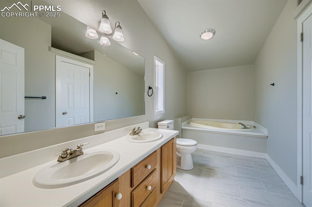 Image 17 of 28: Full bath featuring a garden tub and double vanity