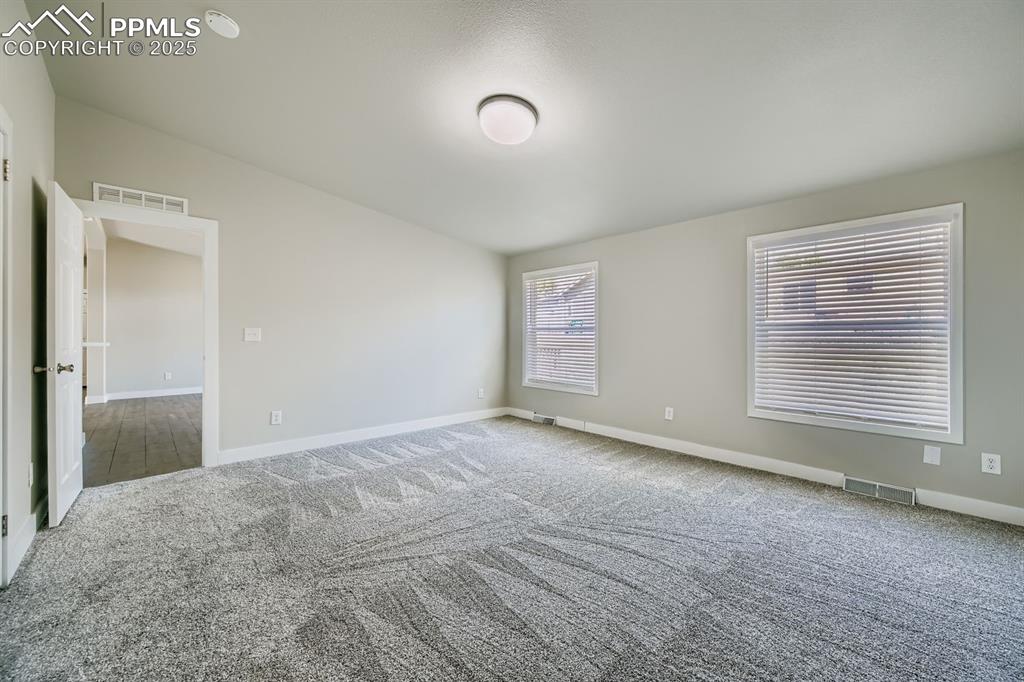 Image 18 of 28: Unfurnished room featuring carpet