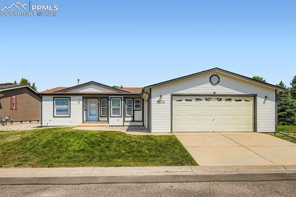 Image 2 of 28: Ranch-style house with driveway, an attached garage, and a front lawn
