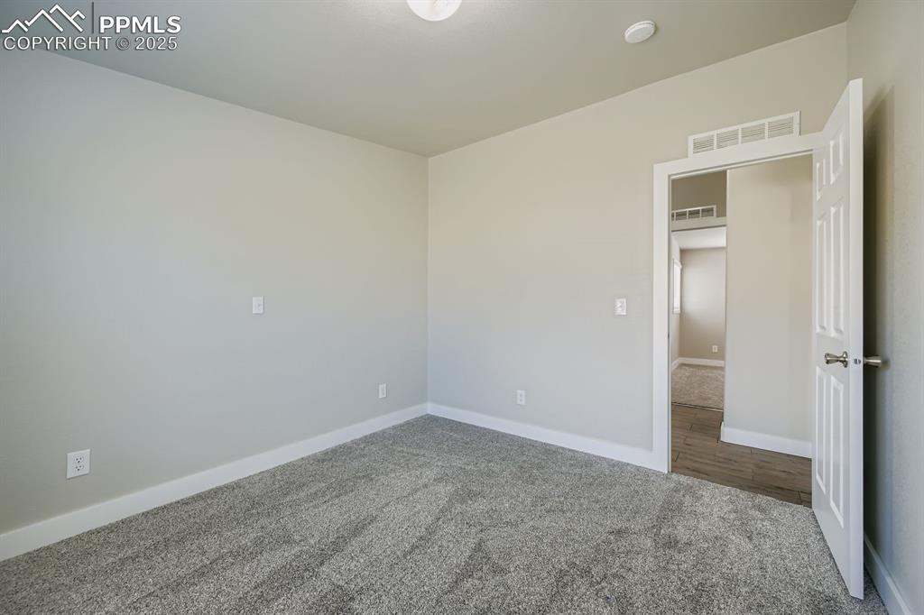 Image 22 of 28: Unfurnished bedroom with carpet and baseboards