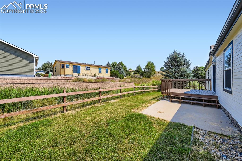 Image 27 of 28: View of yard with a wooden deck