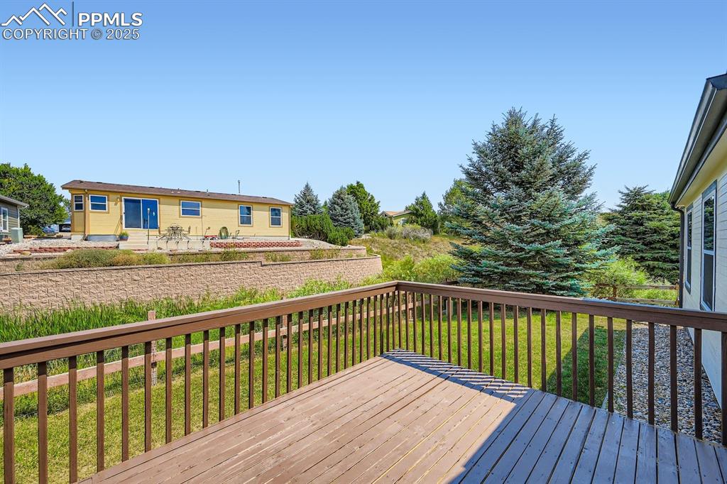 Image 28 of 28: Wooden deck with a lawn