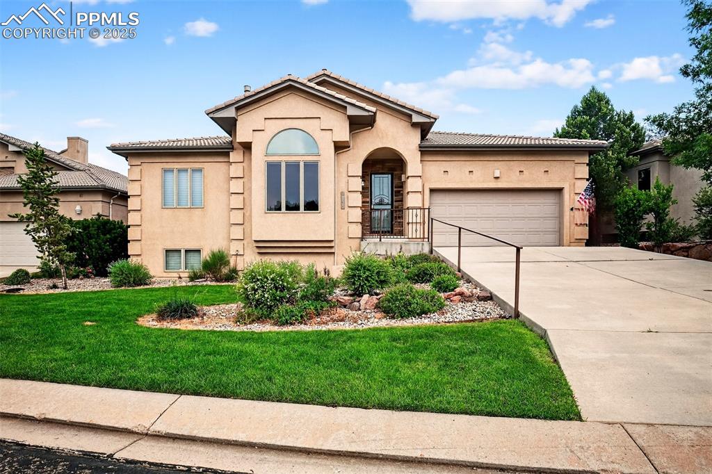 Image 2 of 35: Mediterranean / spanish-style home with stucco siding, a garage, concrete d