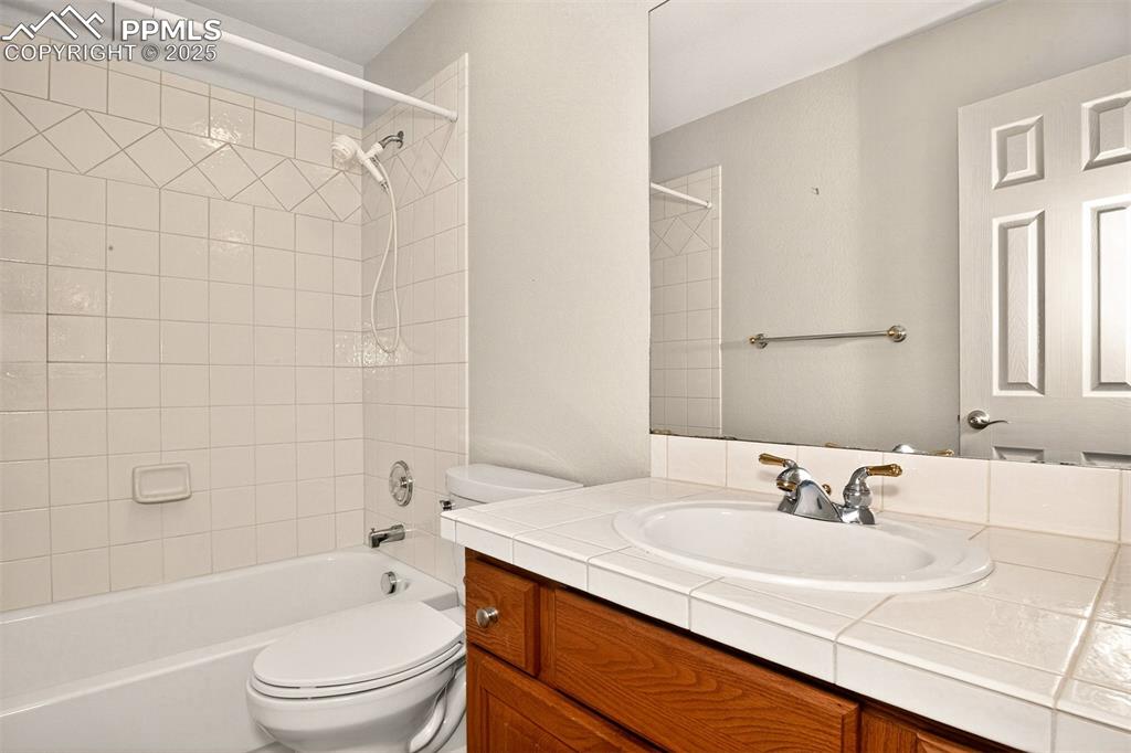 Image 27 of 35: Bathroom with shower / bathtub combination and vanity