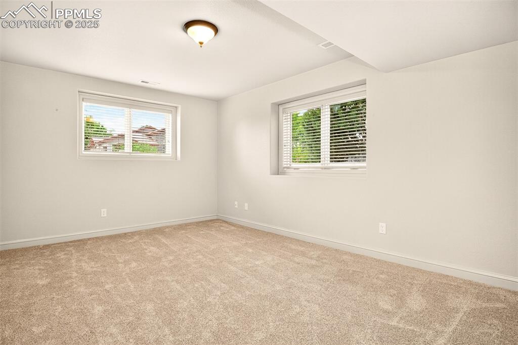 Image 28 of 35: Spare room featuring plenty of natural light and light carpet