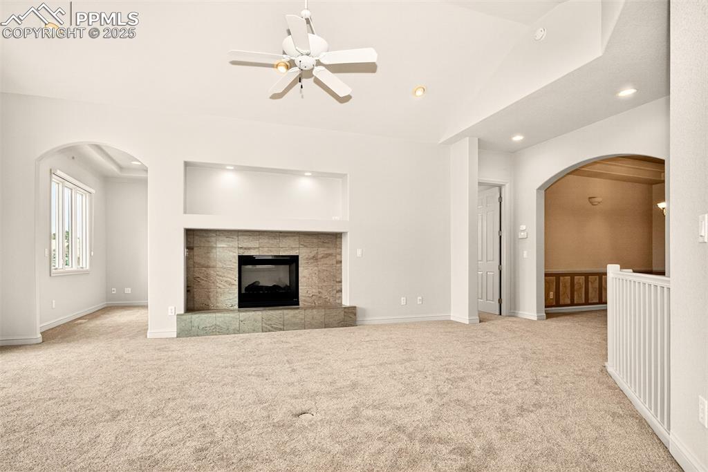 Image 5 of 35: living room featuring arched walkways, ceiling fan, recessed lighting, a ti