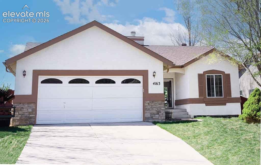 Image 1 of 18: View of front of home with stone and stucco
