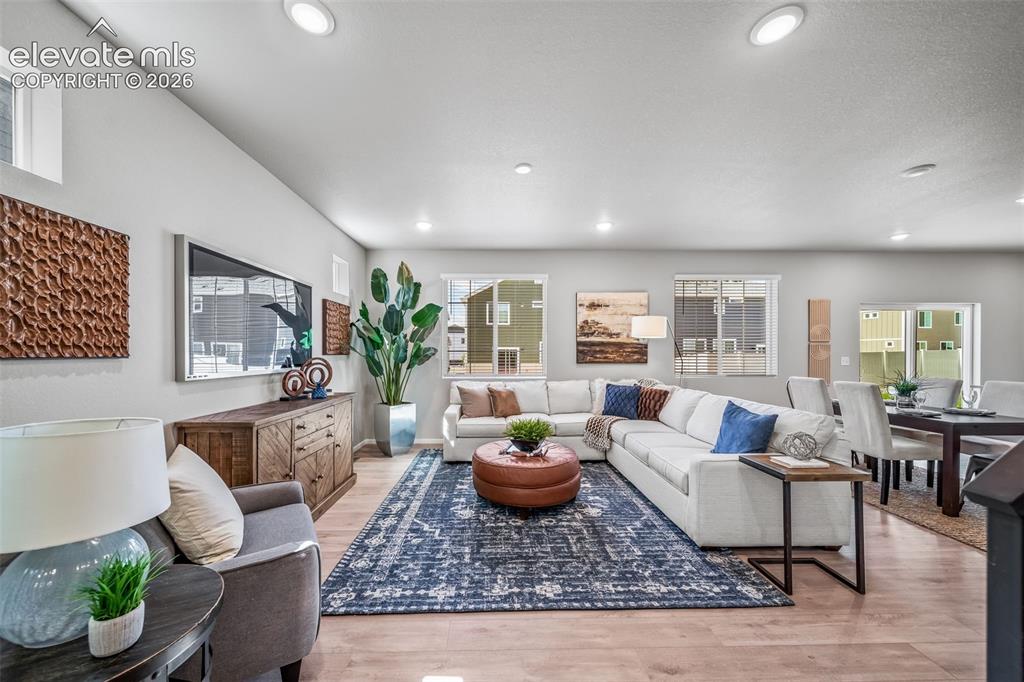 Image 15 of 23: Open-concept living area with light-finish flooring and recessed lighting