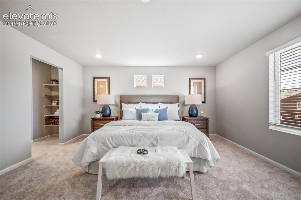 Image 19 of 23: Carpeted bedroom featuring recessed lighting, a window with blinds, and an