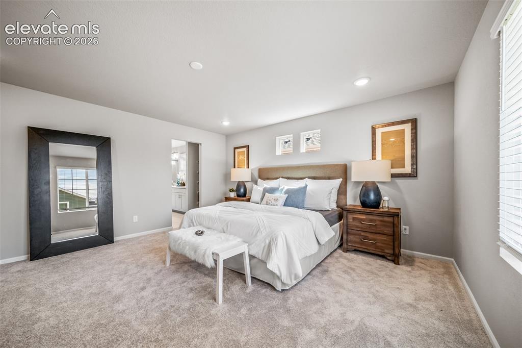 Image 20 of 23: Carpeted bedroom featuring light gray walls, recessed lighting, a window wi