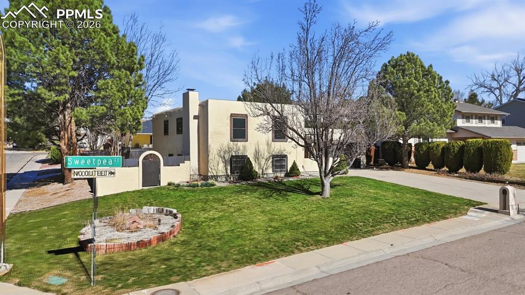 Caption: Beautifully maintained Santa Fe–style tri-level home in the desirable community of University Park a