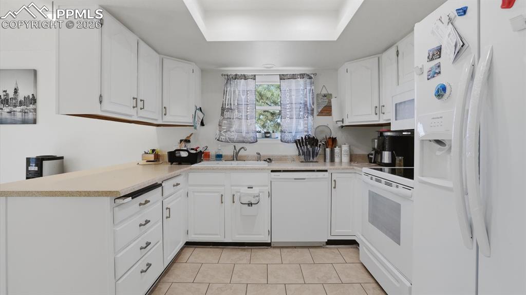 Image 19 of 50: Dining Area with neutral carpet and attractive light fixture.