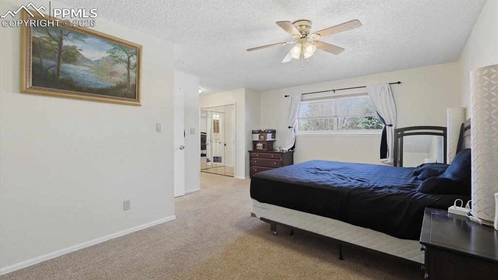 Image 25 of 50: The upper level Primary Bedroom offers a private retreat with neutral carpe