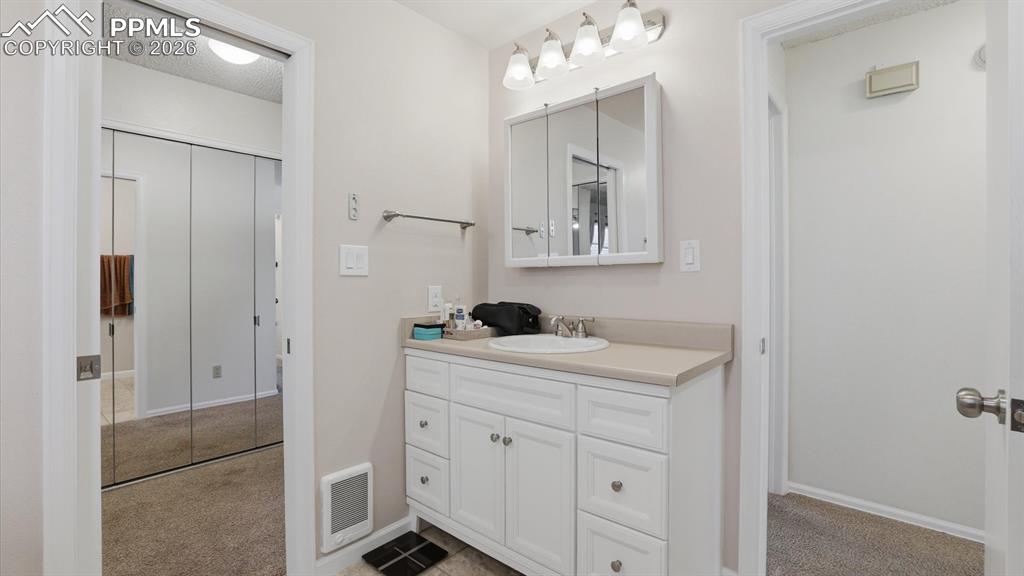 Image 28 of 50: The Primary Bedroom has private access to the Full Hall Bathroom.