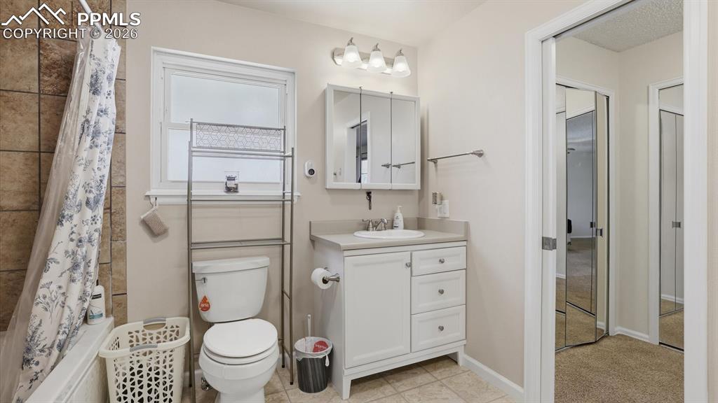 Image 29 of 50: The Upper Level Hall Bathroom offers a tile floor, dual vanities, mirrors,