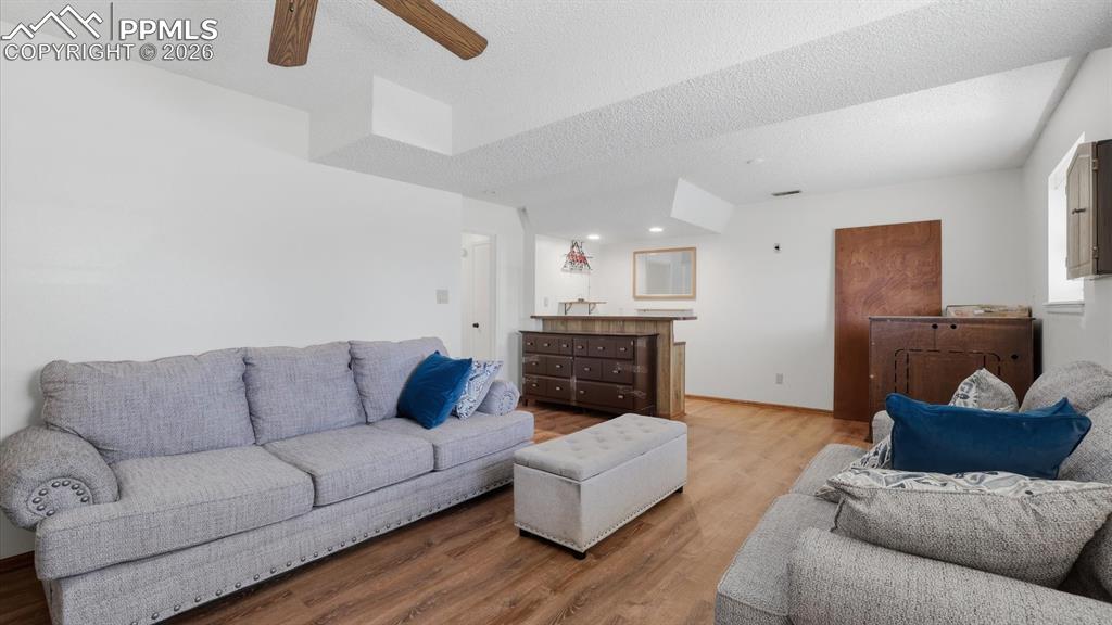 Image 34 of 50: Lower Level Family Room with wet bar.
