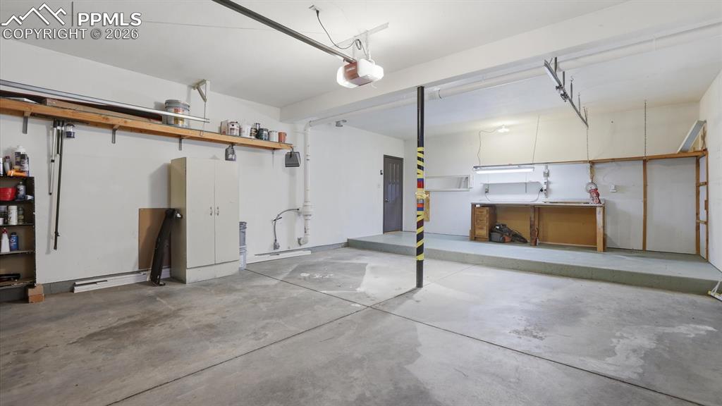 Image 43 of 50: Lower Lever Shower Bathroom with vanity, mirror, and enclosed shower.