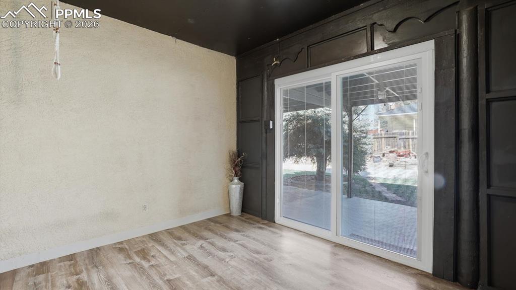 Image 8 of 50: Enclosed covered front porch with pergola