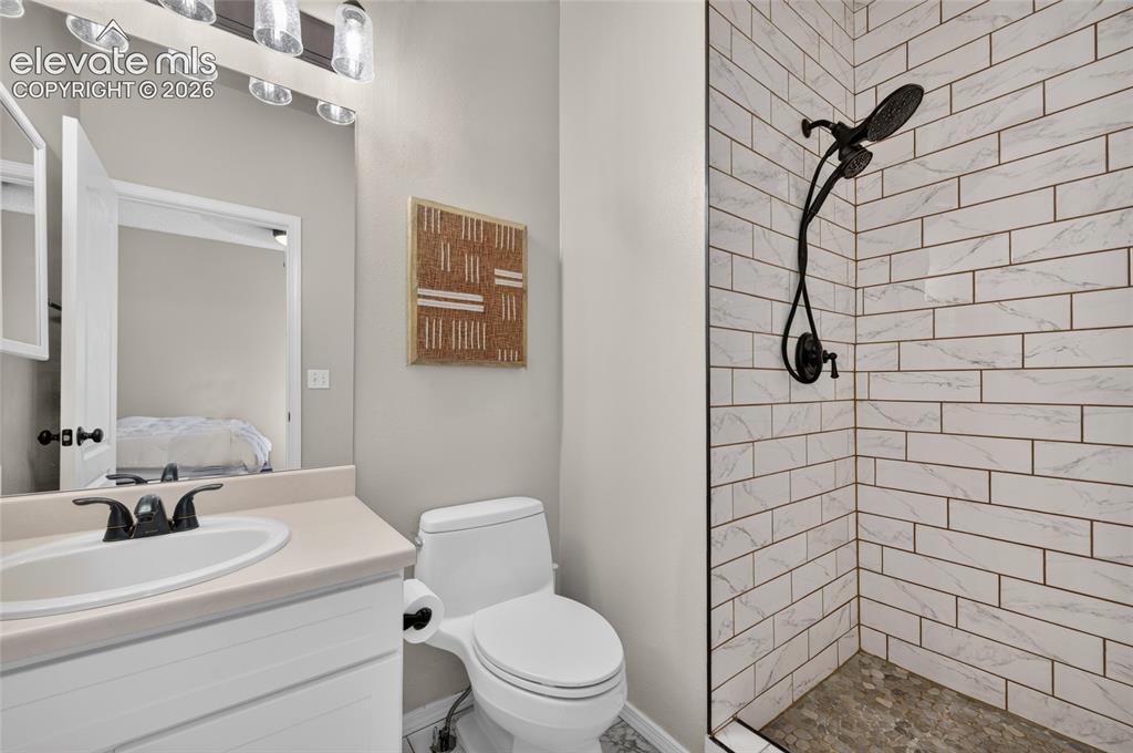 Image 13 of 31: Primary bath redone with tiled floors, tiled shower surround, and new fixtu