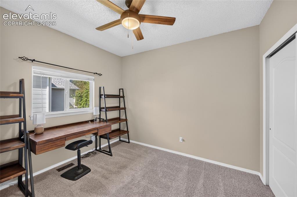 Image 15 of 31: Second main-level bedroom with new ceiling fan