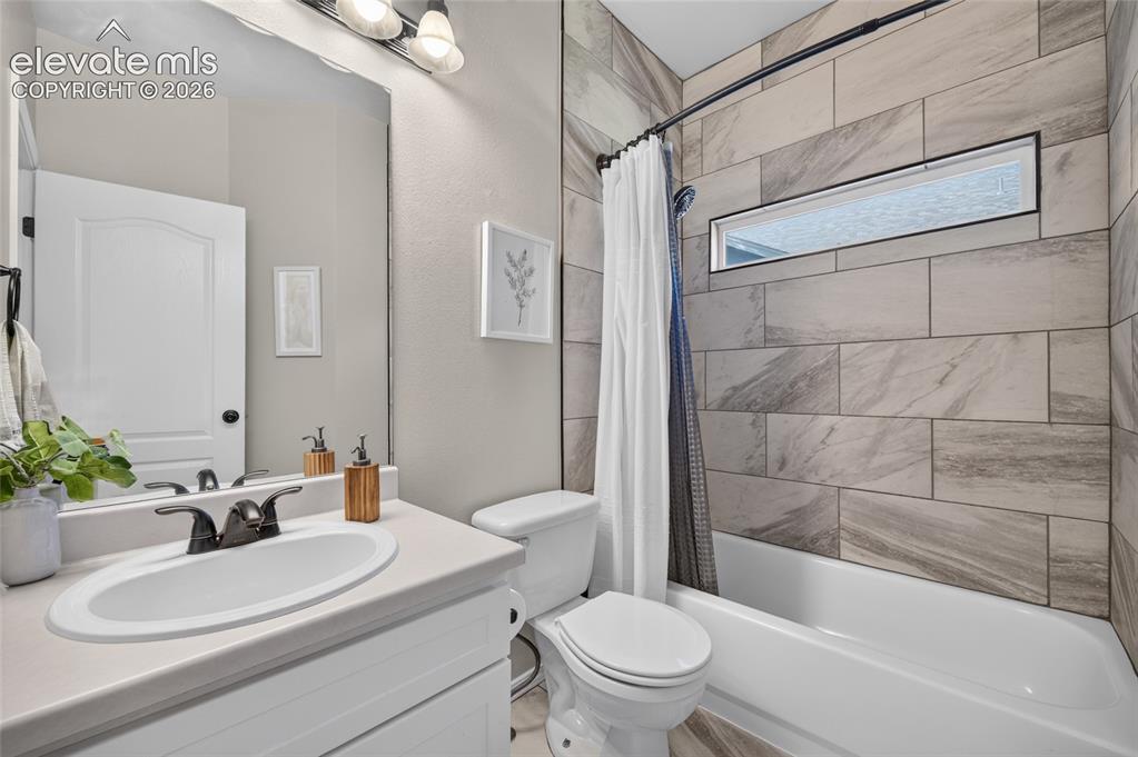 Image 16 of 31: Main-level bath redone with new tile and fixtures