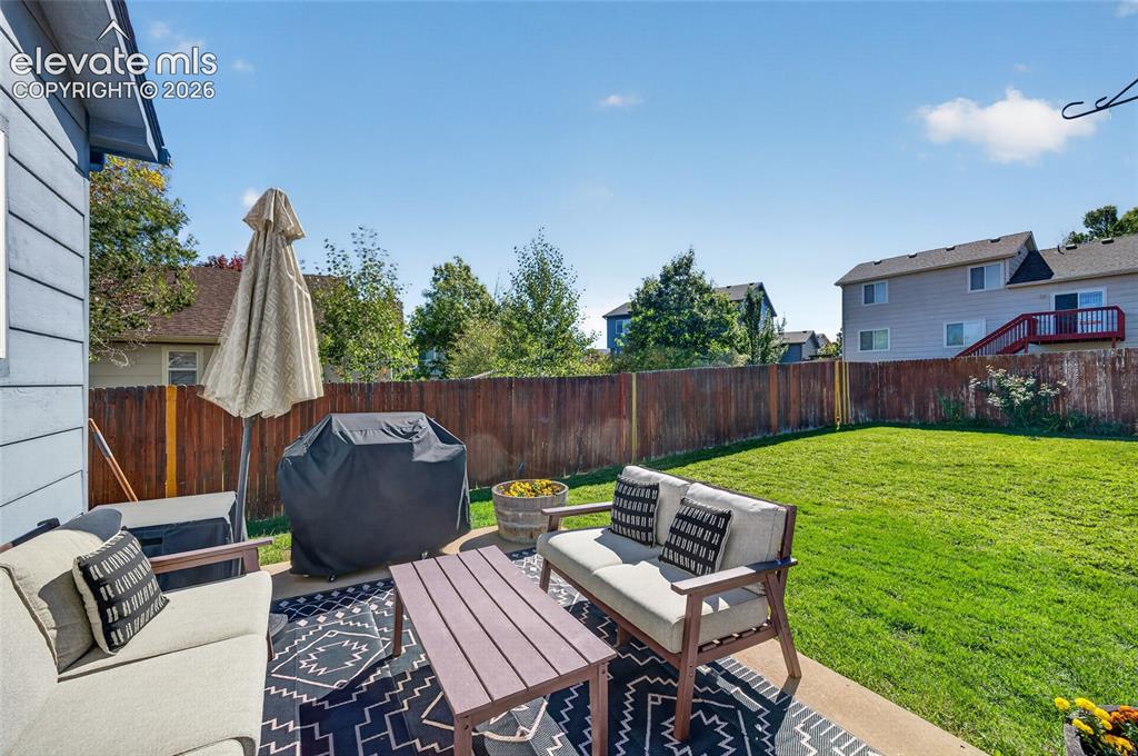 Image 22 of 31: Back patio and fully fenced backyard