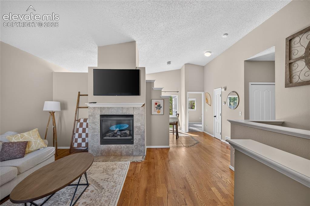 Image 4 of 31: Vaulted ceilings and natural wood floors in the living room