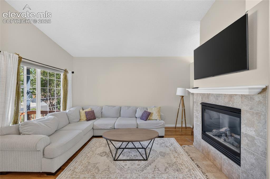 Image 5 of 31: Gas fireplace anchors the living room
