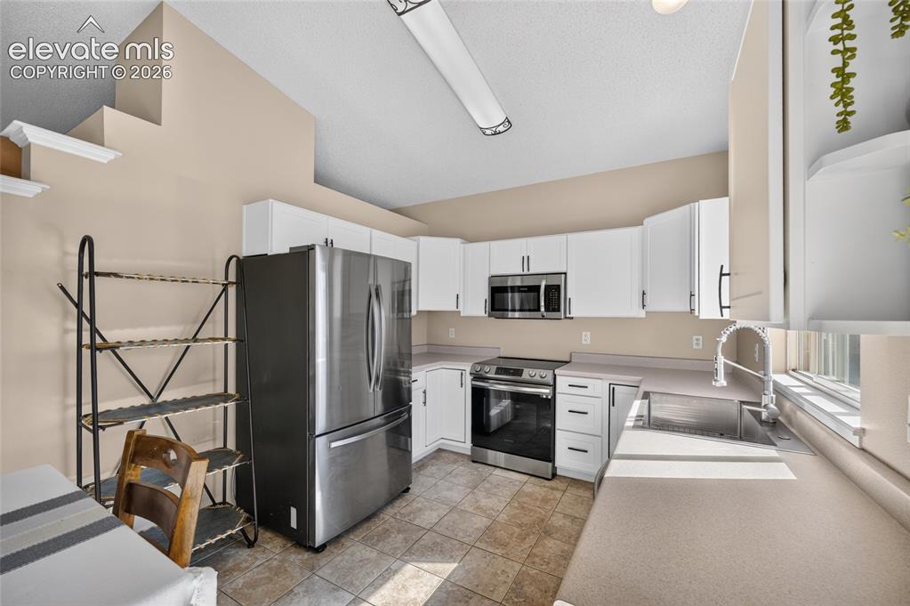 Image 9 of 31: Kitchen with ceramic tile floors