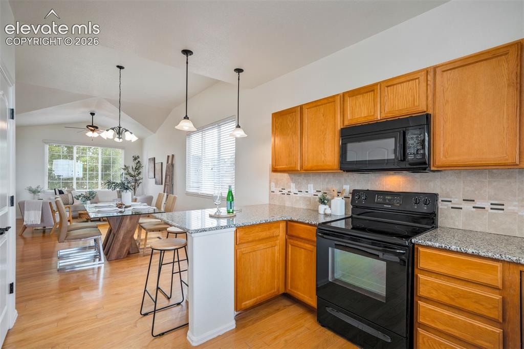 Image 10 of 39: Functional kitchen space opening to the main-level living areas