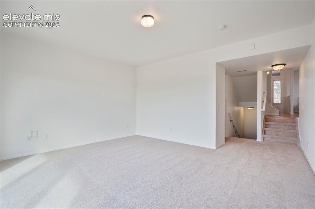 Image 15 of 39: Flexible lower-level bonus room featuring brand-new carpet.