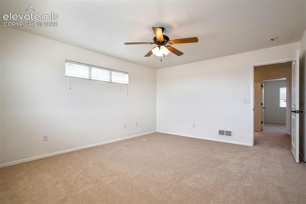 Image 19 of 39: Comfortable primary retreat with fresh paint and new carpet. 