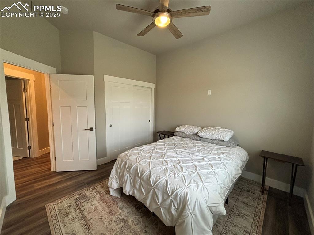Image 15 of 29: Bedroom featuring dark wood finished floors, a closet, and a ceiling fan
