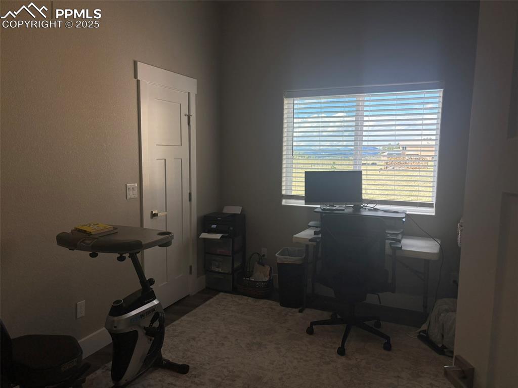 Image 17 of 29: Office area with baseboards and dark wood-type flooring