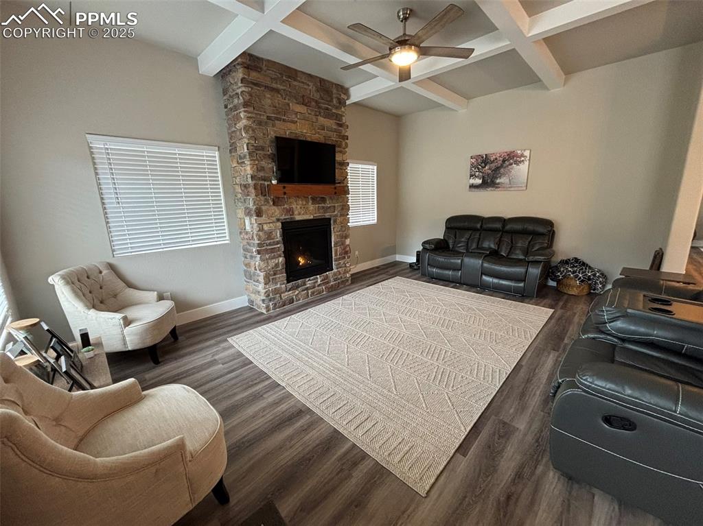 Image 5 of 29: Living area with beamed ceiling, coffered ceiling, dark wood-style flooring